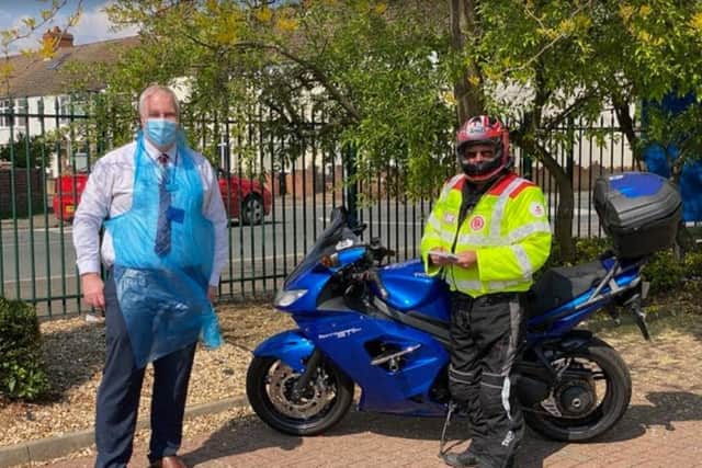 Manager of Abington Pharmacy David Ashton with one of PharmaBike's riders.