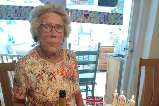 Dolly pictured with her birthday cake, banners and a glass of fizz.