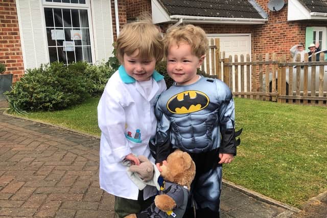 Ethan (left) and Lucas Cooper dressed up as a doctor and Batman for their sponsored walk