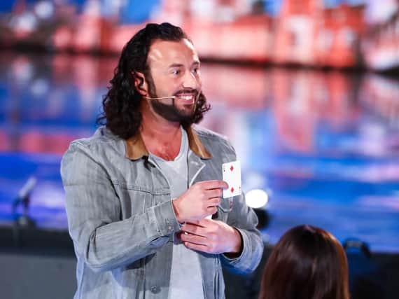 Sean Heydon shows the card Simon Cowell thought of after completing his trick on Britain's Got Talent: Unseen. Photo: Thames Media/ITV