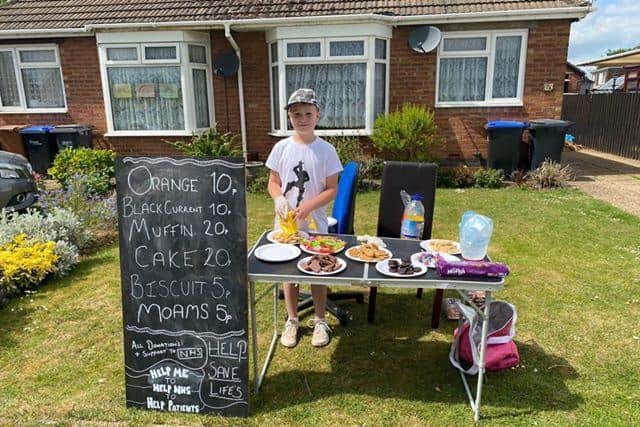 Alfie pictured outside his nan's bungalow in Knightscliffe Way, Duston, where he made more than 100 for NGH.