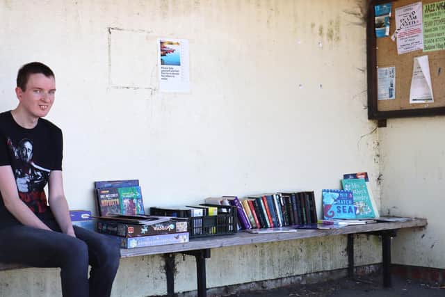 Ben de Boer with the community library based in a disused bus shelter in Hackleton.