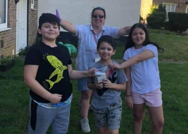 Left to right: Tobias, aged 11, Aijah, aged nine and Nevaiah, aged 10 with the money they have raised for their youth group.