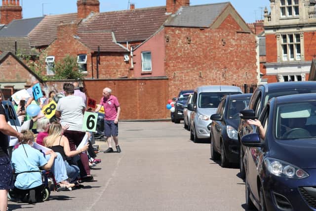 Residents lined the car park to wave to loved ones.
