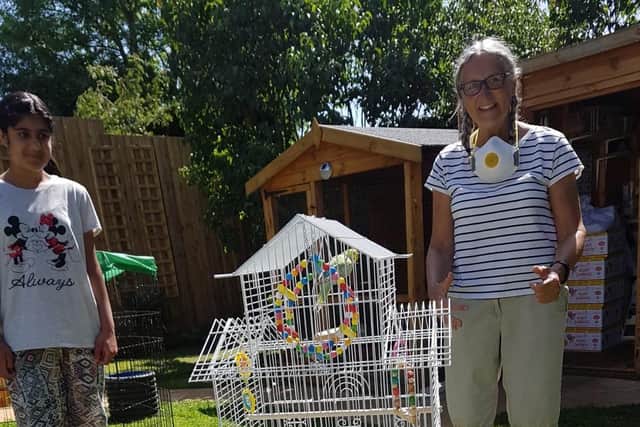 Liz Allen (right) saw the Chron's story and realised she had been feeding the missing budgie in her garden.