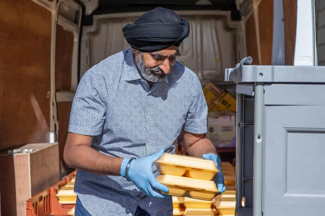 Amarjit Singh Atwal unloads the van ready to feed those staying in the hotel on Thursday evening (May 28).