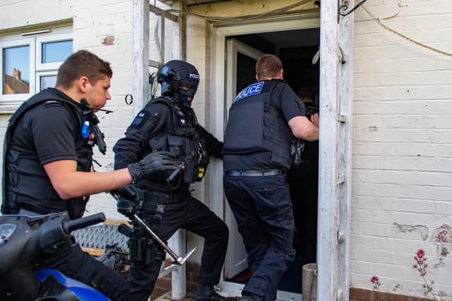 Police crash their way into the property in the St David's area of Northampton. Photos: Northamptonshire Police
