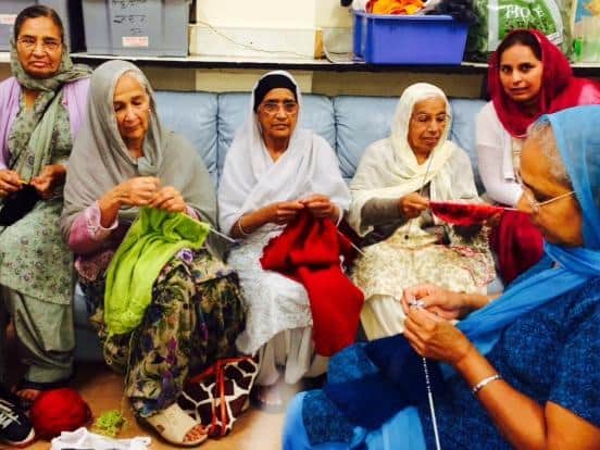 Volunteers knit for care home residents.