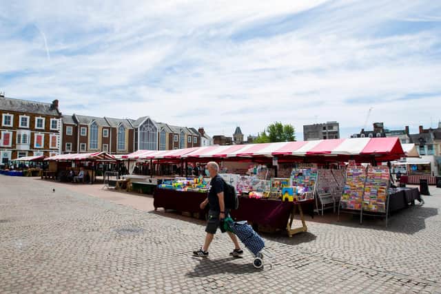 A shopper seen wearing PPE as he strolls across the Market Square. Pictures by Leila Coker.