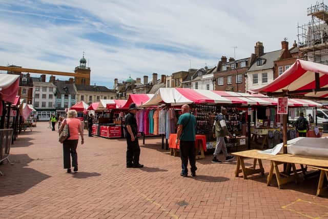 Shoppers stroll round the stalls as open market traders get back to work.