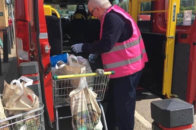 Volunteer, Simon, is pictured loading up the minibus to shop for those in isolation during lockdown.