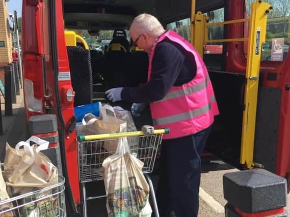 Volunteer, Simon, is pictured loading up the minibus to shop for those in isolation during lockdown.