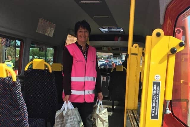 Volunteer Belinda pictured holding shopping bags for those she was delivering to.