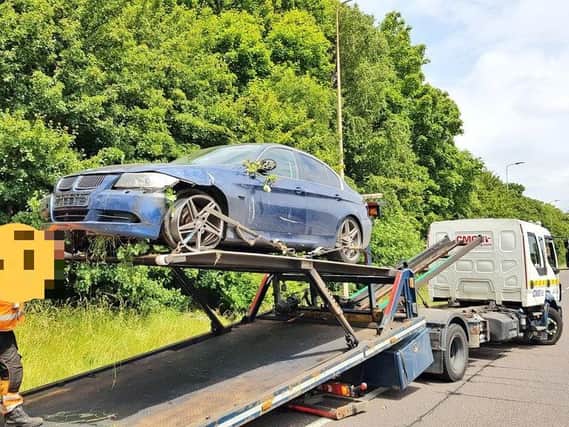 The BMW is recovered after two men fled the scene on the A45 today. Photo: Northamptonshire Police