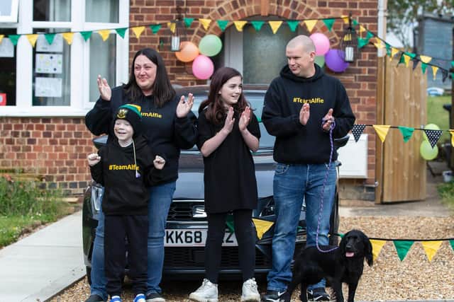 Alfie pictured with his mum Sarah Curtis, sister Katie Andrews and dad Steven Andrews outside their home in Blisworth on Monday evening. Photos by Kirsty Edmonds.