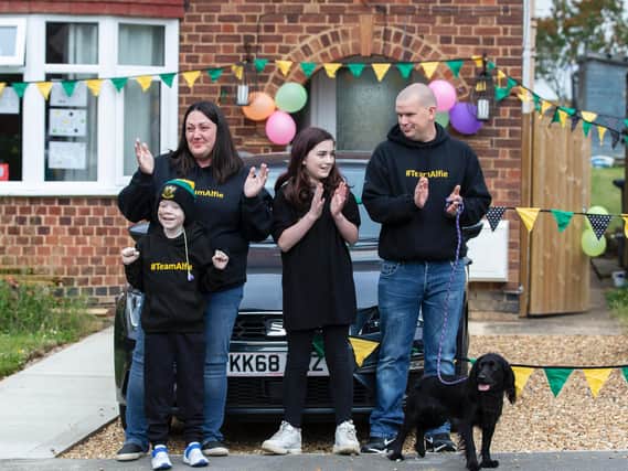 Alfie pictured with his mum Sarah Curtis, sister Katie Andrews and dad Steven Andrews outside their home in Blisworth on Monday evening. Photos by Kirsty Edmonds.