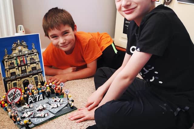 Reggie (left) and Noah Baines with their Lego bullfighting protest. Photo: PETA