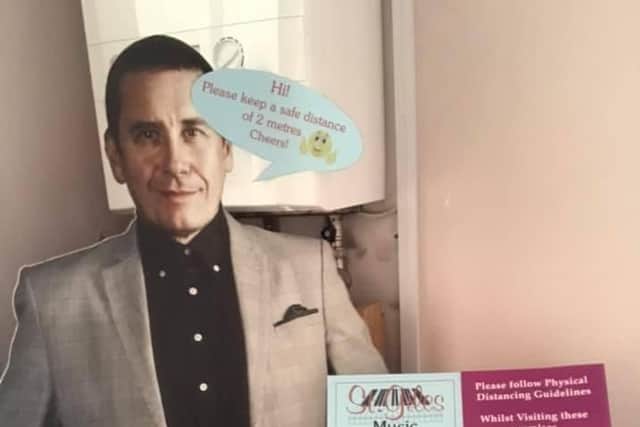 A cardboard cutout of Jools Holland reminds St Giles Music customers to keep their distance