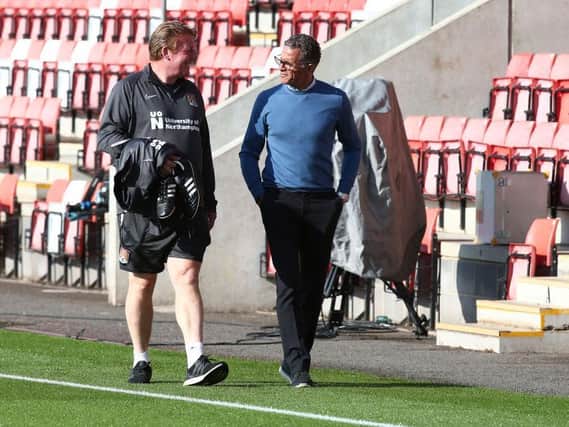 Keith Curle and Ronnie Jepson go for a stroll on the touchline at Whaddon Road.