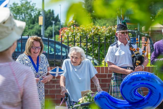 Betty was smiling from ear-to-ear today as she was surprised by a piper and friends in the car park for her birthday. Pictures by Kirsty Edmonds.