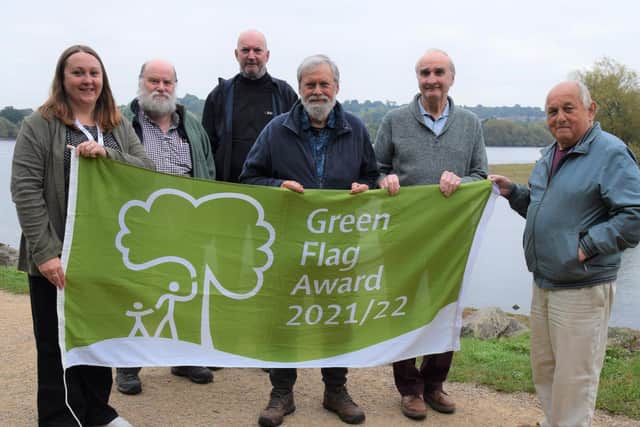 Members of the Friends of Daventry Country Park Committee, West Northamptonshire Council community projects officer Gemma Mason (far left) and park ranger Tony Newby (far right) celebrate the park retaining its Green Flag Award for the 22nd year in a row