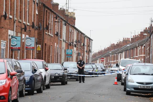 A police officer on the scene outside the house in Wood Street