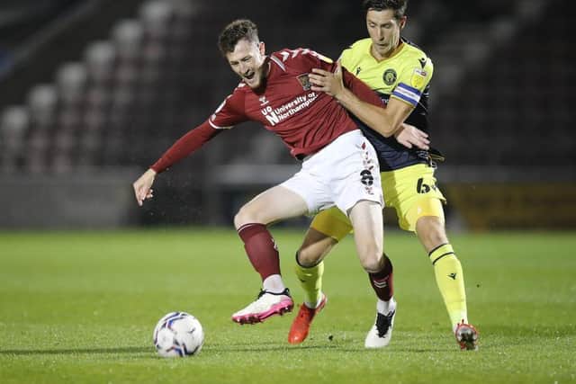 Paul Lewis tussles with Stevenage's Luke Prosser (Picture: Pete Norton)
