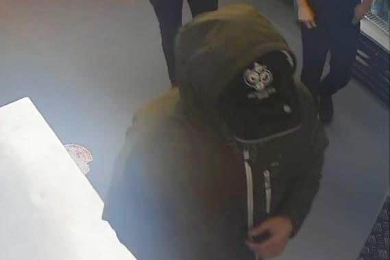 Detectives believe the man in the hat may be able to help investigations into last month's attempted robbery at Domino's Pizza.