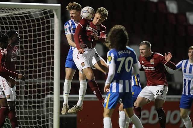 Josh Tomlinson wins this aerial duel from a Cobblers corner (Pictures: Pete Norton)