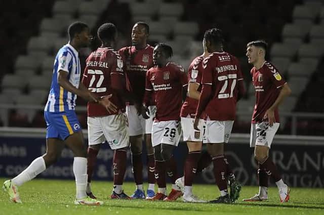 The Cobblers players celebrate Nicke Kabamba's goal against Brighton (Picture: Pete Norton)