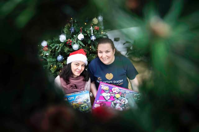 Agnes Schreiber (left) and Teresa McCarthy (right) sit by the Christmas tree with two gifts donated by a member of the public. Photo: Kirsty Edmonds.