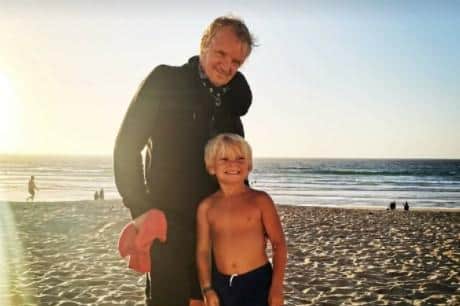Mark at the beach with one of his grandchildren