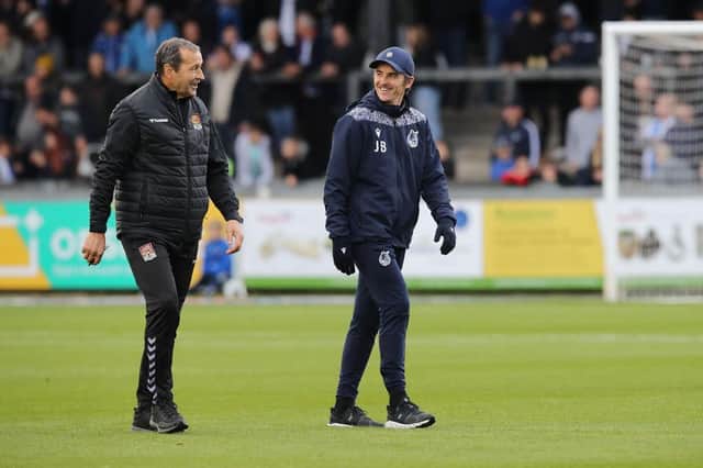 Cobblers assistant Colin Calderwood shares a joke with Joey Barton before Saturday's game.