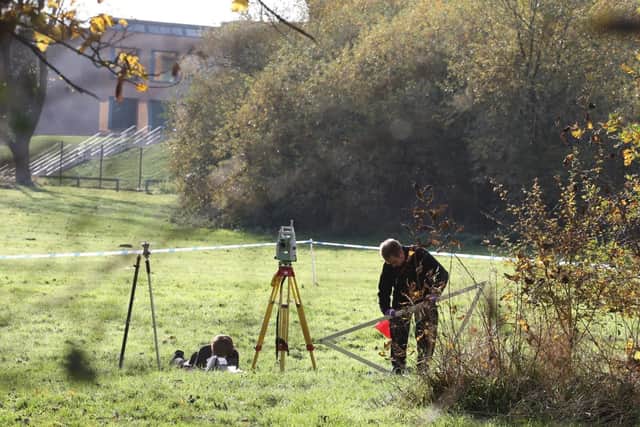 Police search the site.