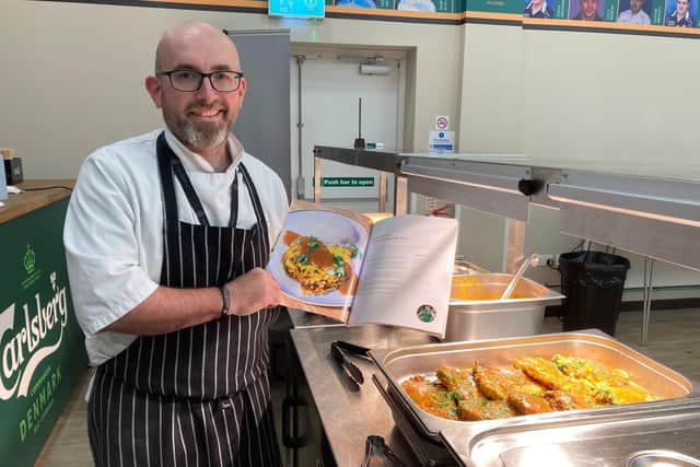 Nick Taylor, Saints head chef and cookbook creator, with his published book.