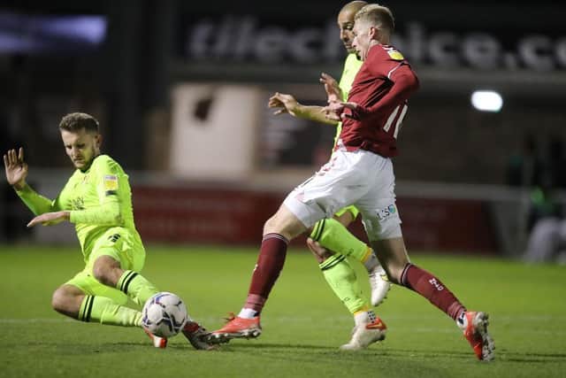 Mitch Pinnock is outnumbered by Orient defenders