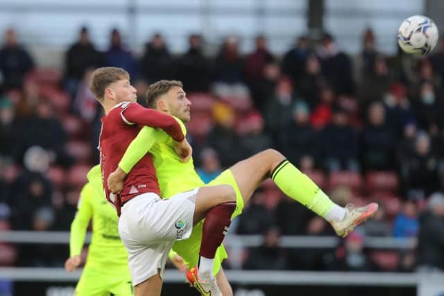 Frazer Horsfall tussles with former Cobblers striker Harry Smith
