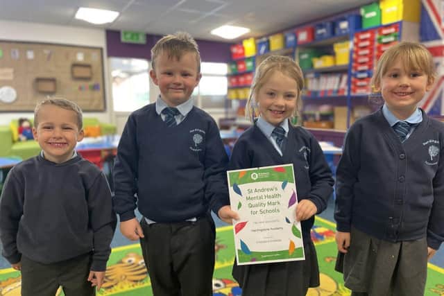Pupils from Hardingstone Academy with their school's accreditation.