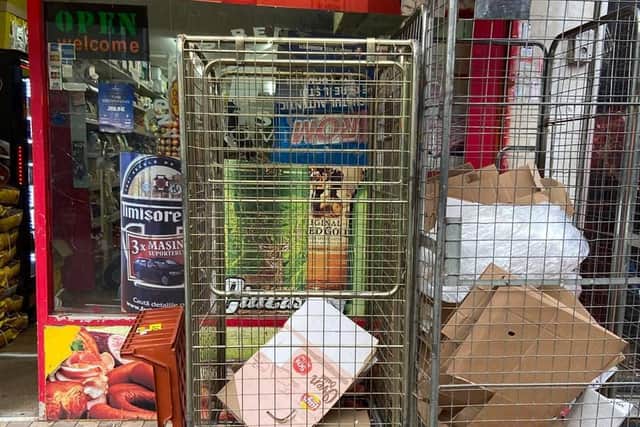 Cages of empty stock left on the pavement in Kettering Road