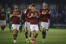 Fraser Horsfall (right) joins his team-mates to applaud the Cobblers' travelling support at Harrogate Town on Saturday (Picture: Pete Norton)