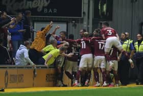 Jon Guthrie and the Cobblers players celebrate the defender's match-winning goal at Newport County in September