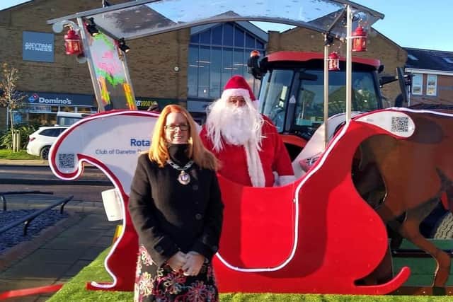 Daventry Mayor Karen Tweedale with Father Christmas in the refurbished sleigh.