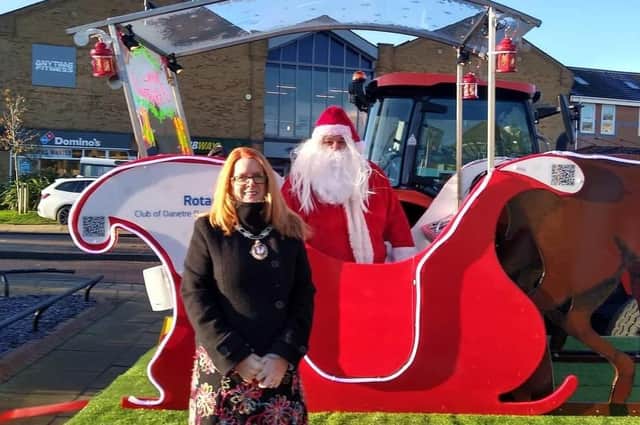 Daventry Mayor Karen Tweedale with Father Christmas in the refurbished sleigh.