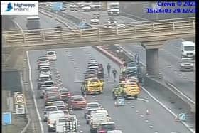 Traffic is being forced into one lane past the scene of a crash on the M1