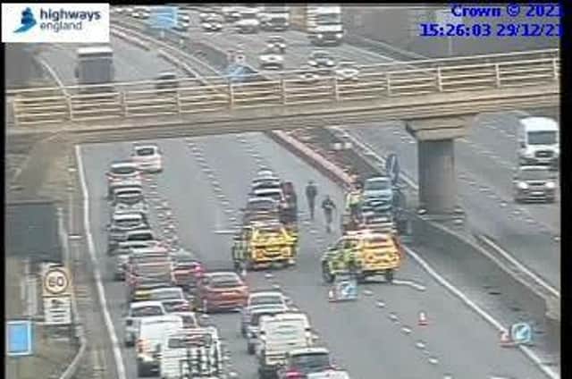 Traffic is being forced into one lane past the scene of a crash on the M1
