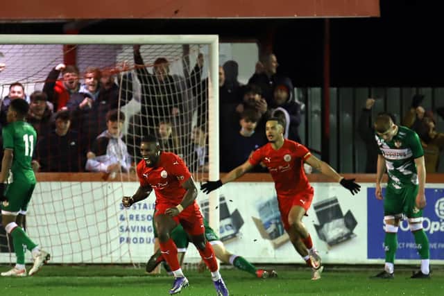 Lee Ndlovu heads off to celebrate after scoring the only goal of the game in Brackley Town's victory over Kettering Town. Picture by Peter Short