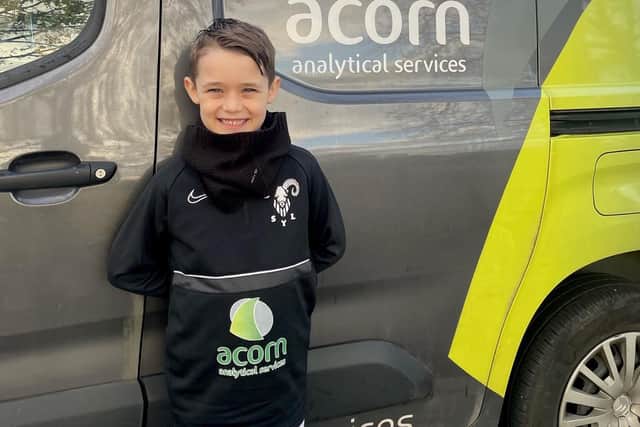 Dan Crask's son Charlie shows off the SYL under-seven Blacks' new top