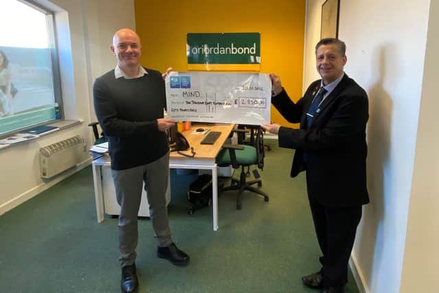 Nick Tite (left) collects the final quarterly cheque.