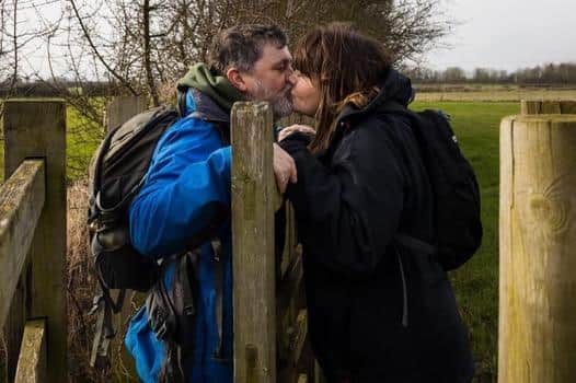 Happily married for 24 years: Martin, 59, and Cathy Finnerty, 49, sharing a kiss on one of their country walks.