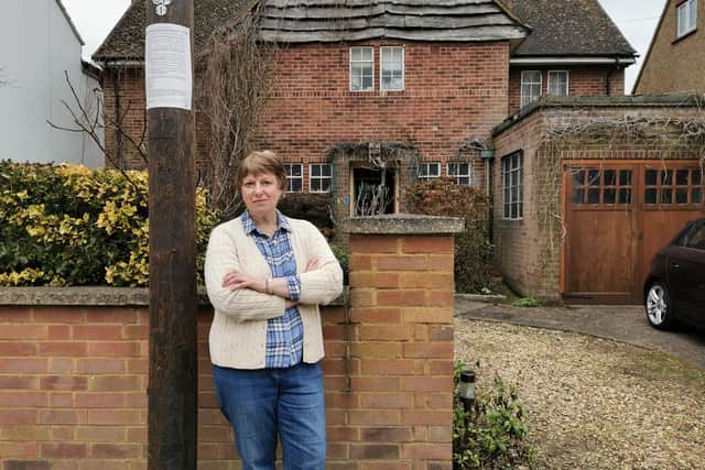 Linda Calvey next to the new pole outside her home in Park Lane, Duston